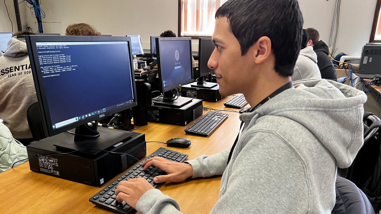 Participants at workstations in an information technology and cyber-security lab